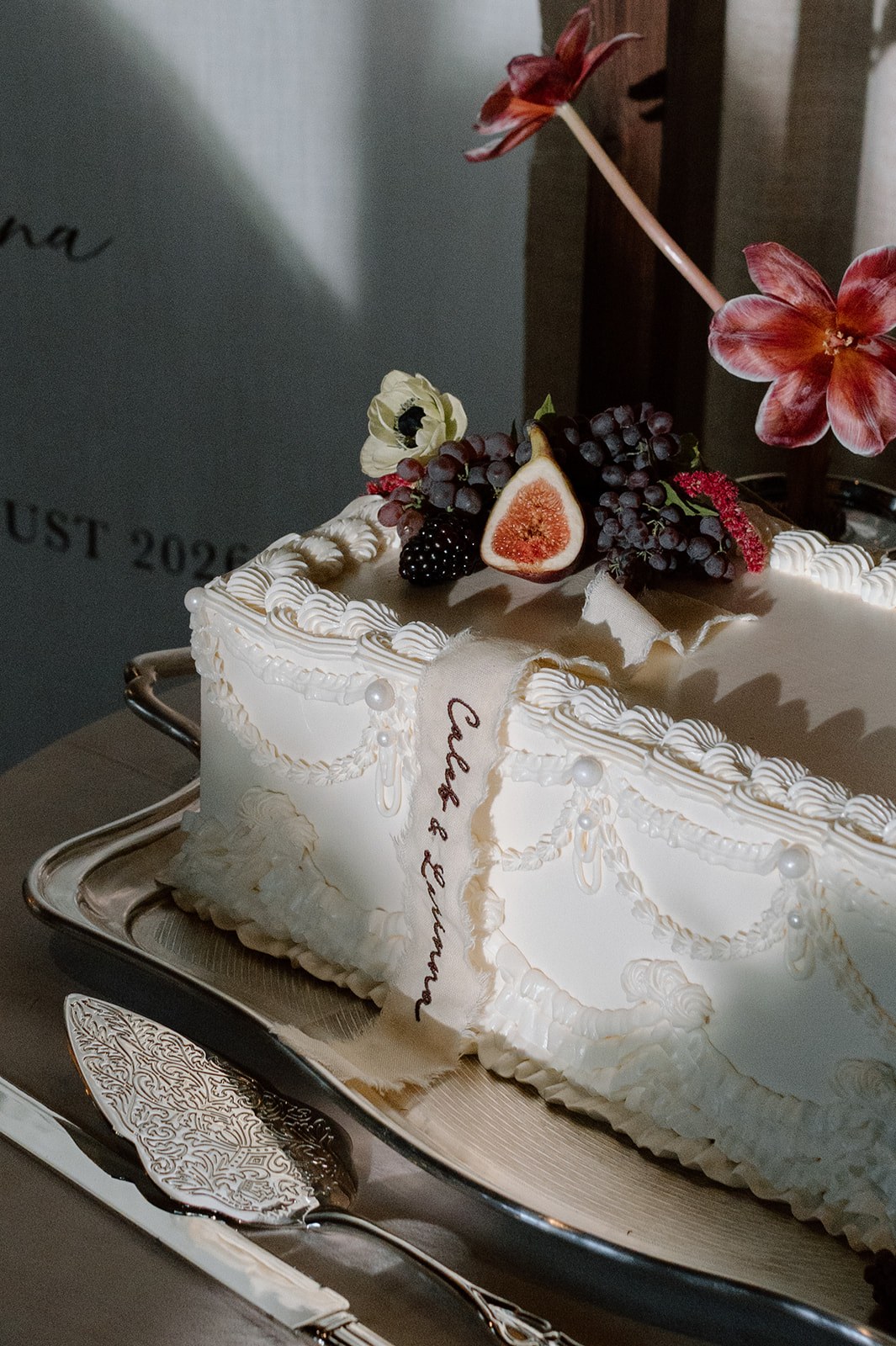 Custom raw-edge heirloom linen ribbon draped over a vintage wedding cake