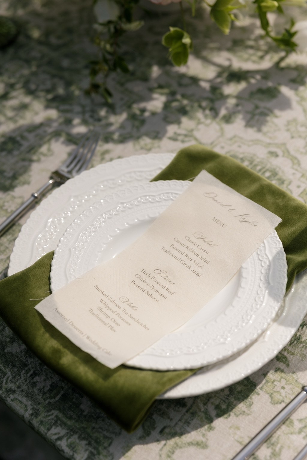 Raw-edge personalized linen wedding menu styled on a place setting
