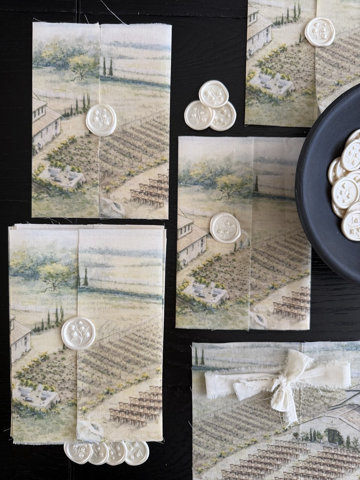 Collection of printed linen invitation wraps with landscape artwork